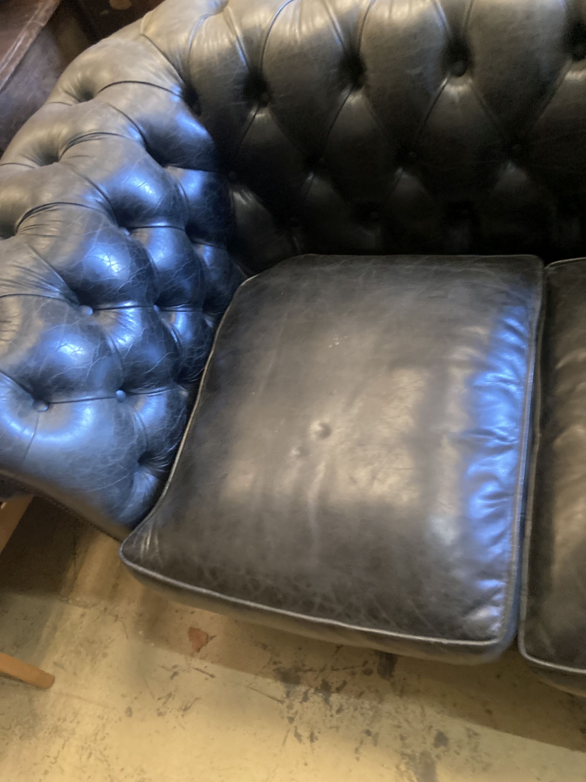 A Fleming & Howland, Chesterfields buttoned black leather three seater Chesterfield settee, length 200cm, depth 86cm, height 74cm